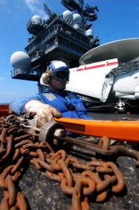 US Navy 060825-N-8604L-092 Aviation Boatswain's Mate Handling Airman Louis Perez watches as an F-18C Hornet is taxied to catapult two aboard USS Kitty Hawk (CV 63)
