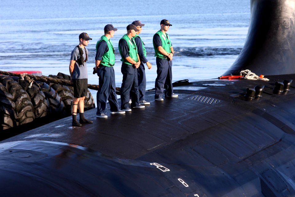 US Navy 060825-N-7441H-002 Sailors stand topside as the Virginia-class attack submarine USS Texas (SSN 775) is guided into port by local tugboats near Port Canaveral