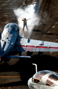 US Navy 060828-N-7130B-362 An aircraft handler directs a U.S. Marine Corps EA-6B Prowler into launch position aboard the Nimitz-class aircraft carrier USS Ronald Reagan (CVN 76)