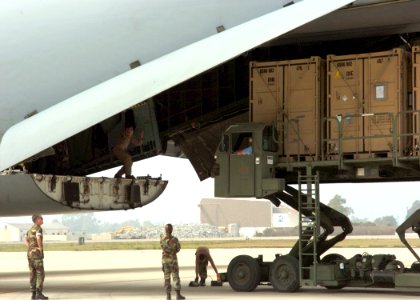 US Navy 060831-N-3560G-052 Members of Naval Mobile Construction Battalion Four (NMCB-4) load Tricon Containers loaded with construction equipment destine for field testing in Iraq, into a U.S. Air Force, Air Mobility Command, C