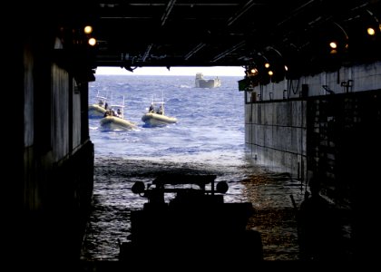 US Navy 060831-N-6616W-070 Landing Craft Utility (LCU) 1658 and several Ridged Hulled Inflatable Boats (RHIB) prepare to enter the well-deck aboard the amphibious assault ship USS Saipan (LHA 2)