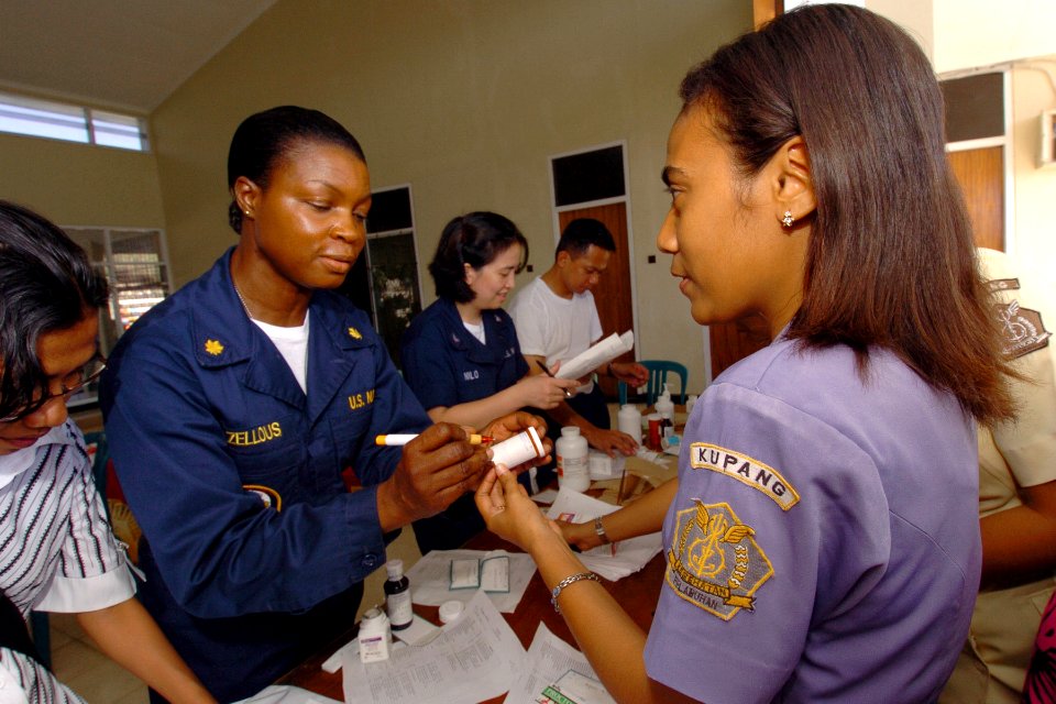 US Navy 060823-N-6501M-114 U.S. Navy Lt. Cmdr. Sheron Zellous of San Diego, explains to an Indonesian assistant the proper use of the medications being dispensed