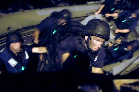 US Navy 060828-N-8298P-006 Visit Board Search and Seizure (VBSS) team member, Operations Specialist 2nd Class Glenn Kettering, along with other VBSS members assigned to guided-missile destroyer USS Carney (DDG 64) photo