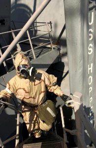 US Navy 060901-N-9851B-003 Hull Technician 3rd Class Marc Brandes wears an Advanced Chemical Protective Garment (ACPG) while leading an external survey team