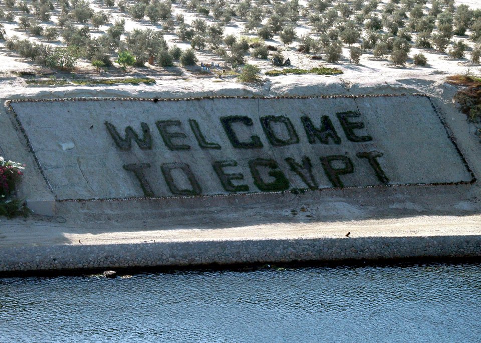 US Navy 060902-N-8547M-038 The amphibious assault ship USS Saipan (LHA 2) pass a Welcome to Egypt sign as the ship transits the Suez Canal