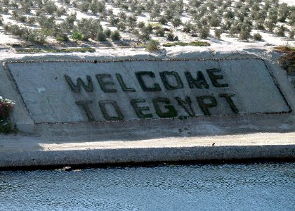 US Navy 060902-N-8547M-038 The amphibious assault ship USS Saipan (LHA 2) pass a Welcome to Egypt sign as the ship transits the Suez Canal