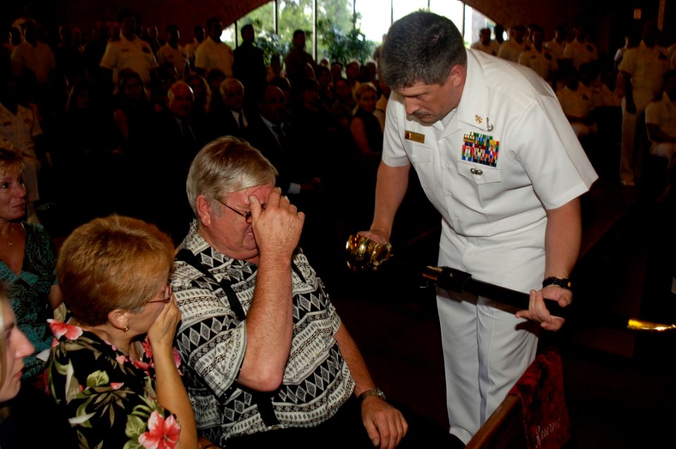 US Navy 060829-N-5555T-007 Chief Explosive Ordnance Disposal Technician Paul J. Darga's father receives a chief petty officer's ceremonial cutlass in honor of his late son