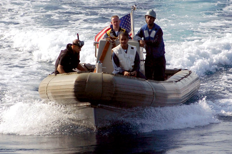 US Navy 060829-N-8604L-103 A Rigid Hull Inflatable Boat (RHIB) returns to the USS Kitty Hawk (CV 63) after conducting a small boat in distress and rescue drill