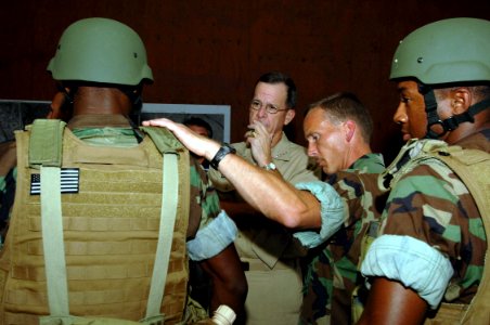 US Navy 060829-N-5758H-067 Chief of Naval Operations (CNO) Adm. Mike Mullen listens to Riverine Squadron One's Command Master Chief Kyle Reagan, explain the features of the combat vest during a visit of Riverine Group One (RIVR