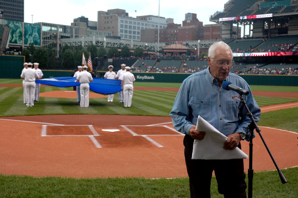 US Navy 060830-N-1805P-005 Major League Baseball Hall of Fame Inductee and World War II Navy veteran Bob Feller accepts a Cleveland Indians Chief Wahoo logo flag presented to him by amphibious transport dock ship USS Cleveland