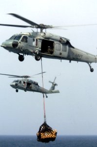 US Navy 060826-N-8604L-107 Two MH-60S Seahawks from Helicopter Sea Combat Support Squadron (HCS-25) transfers cargo from the Military Sealift Command (MSC) combat stores ship USNS Concord (T-AFS 5) to the aircraft carrier USS
