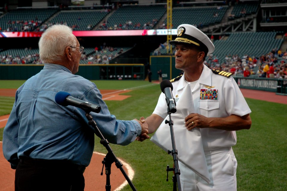 US Navy 060830-N-1805P-006 Amphibious transport dock ship USS Cleveland (LPD 7) Commanding Officer Capt. Frank McCulloch accepts a Cleveland Indians flag presented to him by Major League Baseball Hall of Fame Inductee and World