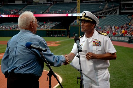 US Navy 060830-N-1805P-006 Amphibious transport dock ship USS Cleveland (LPD 7) Commanding Officer Capt. Frank McCulloch accepts a Cleveland Indians flag presented to him by Major League Baseball Hall of Fame Inductee and World
