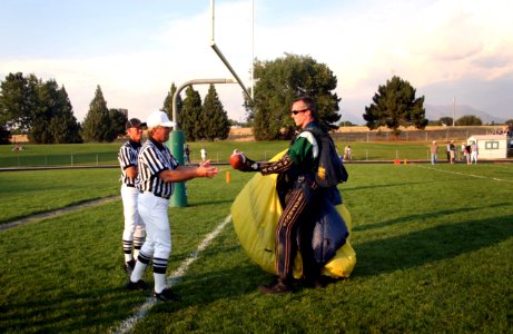 US Navy 060908-N-3271W-004 Lt. Geoff Reeves, a member of the U.S. Navy Parachute Demonstration Team Leap Frogs hands the game ball over photo