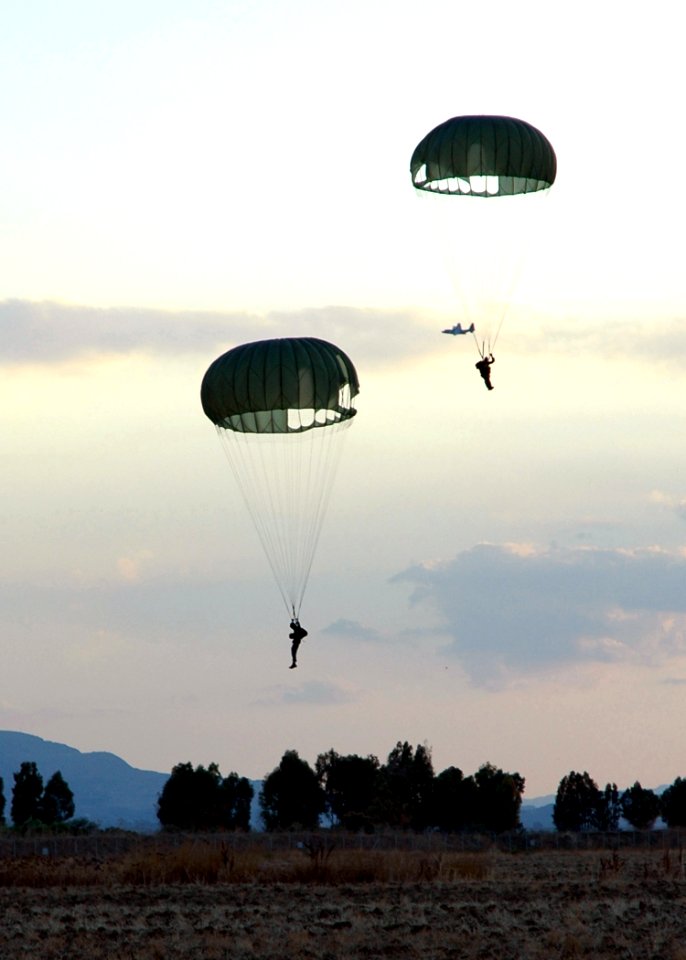 US Navy 060828-N-0577G-013 Members of Explosive Ordnance Mobile Unit Eight (EODMU-8), complete parachute training jump on board Naval Air Station (NAS) Sigonella