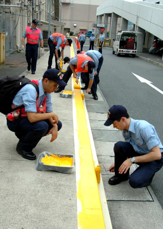 US Navy 060830-N-1332Y-045 Sailors assigned to the aircraft carrier USS Kitty Hawk (CV 63) apply fresh yellow paint to street curbs around Commander, Fleet Activities Yokosuka