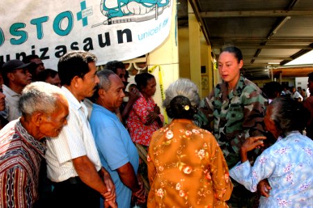 US Navy 060829-N-3714J-032 Master-at-Arms 2nd Class Kristen J. Maxwell instructs patients to stand in line while waiting to be seen by a doctor at a local clinic photo