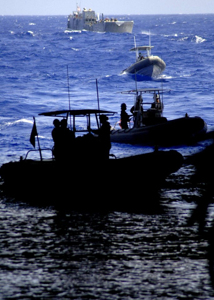US Navy 060831-N-6616W-089 Landing Craft Utility (LCU) 1658 and several Ridged Hulled Inflatable Boats (RHIB) assigned to Helicopter Mine Countermeasures Squadron One Five wait to enter the well-deck aboard the amphibious assau