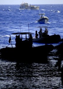 US Navy 060831-N-6616W-089 Landing Craft Utility (LCU) 1658 and several Ridged Hulled Inflatable Boats (RHIB) assigned to Helicopter Mine Countermeasures Squadron One Five wait to enter the well-deck aboard the amphibious assau