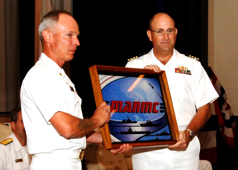 US Navy 060829-N-5758H-001 Command Master Chief Ronald F. Bennett presents the Mid-Atlantic Regional Maintenance Center flag to Capt. Kevin B. Taylor during a Change of Command ceremony at Naval Station Norfolk