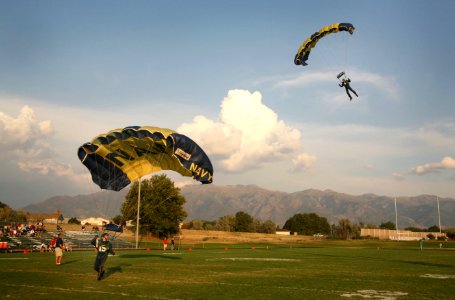 US Navy 060908-N-3271W-002 Members of the U.S. Navy Parachute Demonstration Team Leap Frogs land in the Clearfield High School football field prior the school's season opener photo