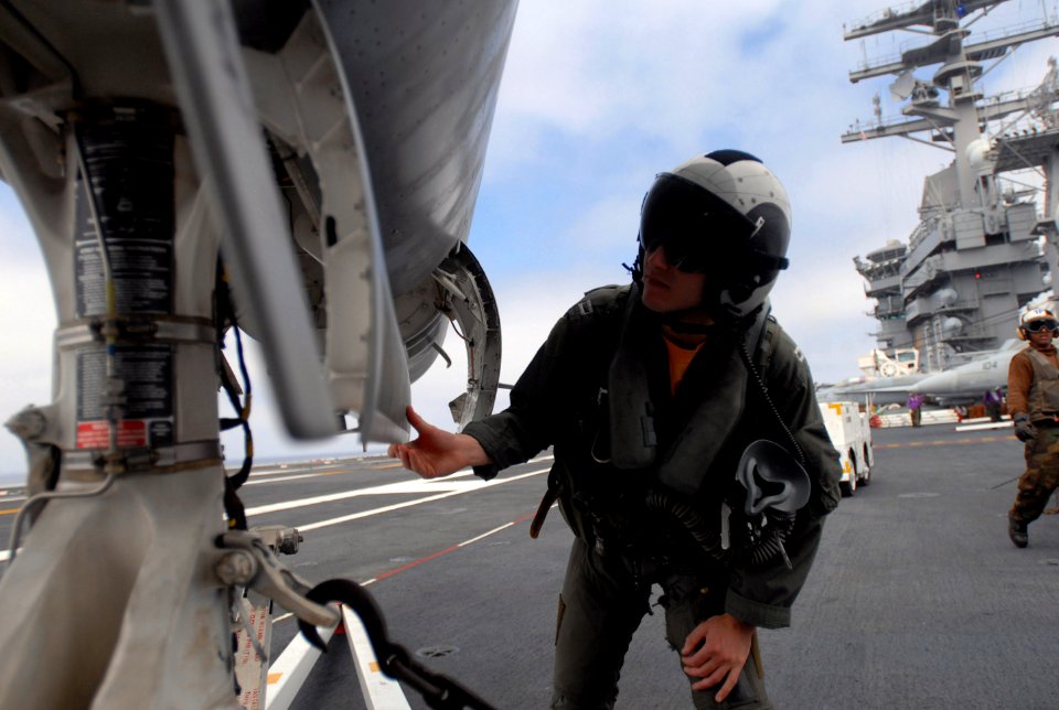 US Navy 060831-N-8158F-053 A Navy pilot assigned to the Eagles of Strike Fighter Squadron One One Five (VFA-115) performs final aircraft checks prior to flight operations aboard the nuclear-powered aircraft carrier USS Nimitz (