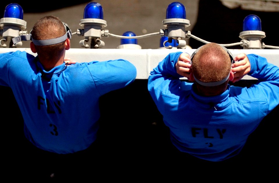 US Navy 060828-N-7130B-279 High above the flight deck aboard the Nimitz-class aircraft carrier USS Ronald Reagan (CVN 76), members of the ships Air Department watch as aircraft prepare to land during flight operations