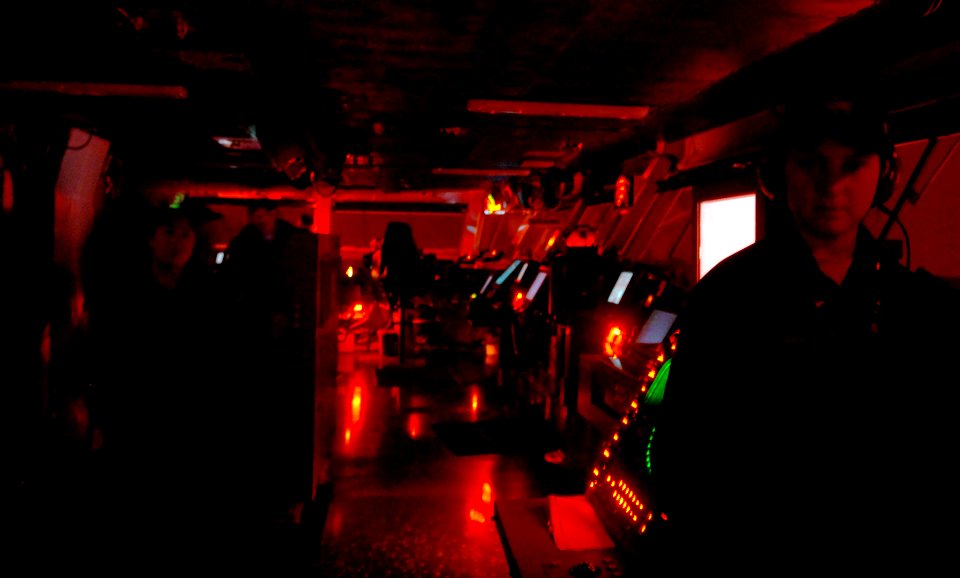 US Navy 061116-N-4776G-118 The bridge aboard USS Ronald Reagan (CVN 76) is aglow with red lights as the watch team keeps a vigilant post over their crew through the night