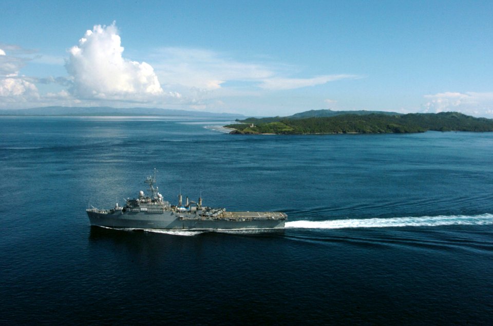 US Navy 061104-N-5067K-130 The amphibious transport dock ship USS Juneau (LPD 10) passes the Capul Island Lighthouse as it transits through the San Bernardino Straits