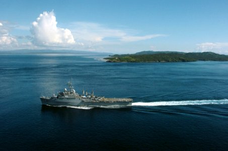 US Navy 061104-N-5067K-130 The amphibious transport dock ship USS Juneau (LPD 10) passes the Capul Island Lighthouse as it transits through the San Bernardino Straits
