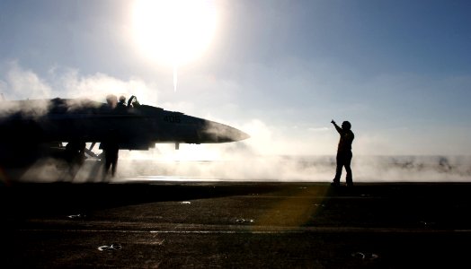 US Navy 061116-N-5961C-001 As the steam passes by from the last jet aircraft launched, another is moved into position on the flight deck of USS Ronald Reagan (CVN 76)