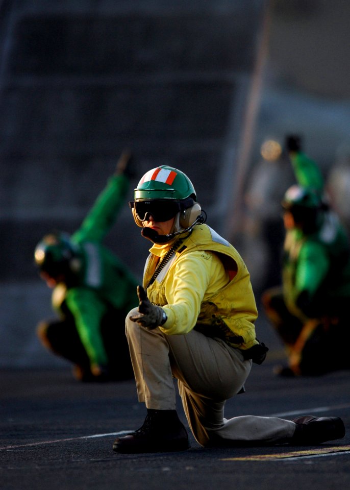 US Navy 061111-N-0490C-001 Lt. Shannon Clark, a catapult officer kneels to launch an aircraft from the flight deck of the Nimitz-class aircraft carrier USS Dwight D. Eisenhower (CVN 69)