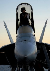 US Navy 061116-N-4776G-345 Airman Matthew Haysler wipes down the windows on the hatch of an F-A-18E Super Hornet prior to flight operations aboard USS Ronald Reagan (CVN 76)