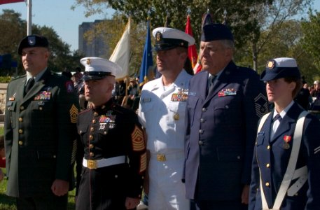 US Navy 061111-N-3750S-016 USS San Antonio (LPD 17) Command Master Chief Tom Meglen, center, participates in the wreath laying ceremony with representatives all branches of the military services during the Veterans Day ceremony