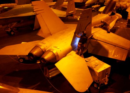 US Navy 061110-N-6364G-574 Sailors conduct routine maintenance on an F-A-18C Hornet assigned to Strike Fighter Squadron One Four Seven (VFA-147) in the hangar bay aboard the nuclear-powered aircraft carrier USS John C. Stennis
