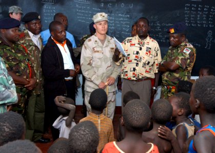 US Navy 061103-N-1328C-548 Deputy Commander of Combined Joint Task Force - Horn of Africa (JTF-HOA), U.S. Navy Rear Adm. Tim Moon (center), receives a tour from Kenyan Army Brig. Gen. Leornard Ngondi photo