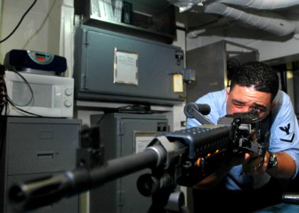 US Navy 061107-N-2659P-109 Gunner's Mate 3rd Class Marc Williams tests the sights of the M240-B machine-gun aboard the nuclear-powered aircraft carrier USS John C. Stennis (CVN 74)