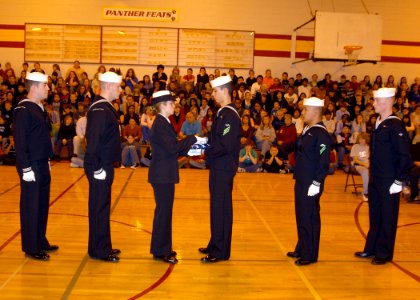 US Navy 061109-N-6247M-004 Sailors assigned to Naval Air Station Whidbey Island perform the 'Passing of the Flag' ceremony at Oak Harbor Middle School photo