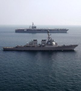 US Navy 061115-N-0490C-001 The Arleigh Burke-class guided-missile destroyer USS Ramage (DDG 61) sails alongside the Nimitz-class aircraft carrier USS Dwight D. Eisenhower (CVN 69) during a vertical replenishment (VERTREP)