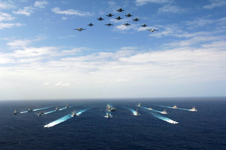 US Navy 061114-N-8591H-147 Aircraft assigned to Carrier Air Wing Five (CVW-5) fly over a group of 18 U.S. and Japanese Maritime Self-Defense Force ships, at the conclusion the two nations' exercise ANNUALEX