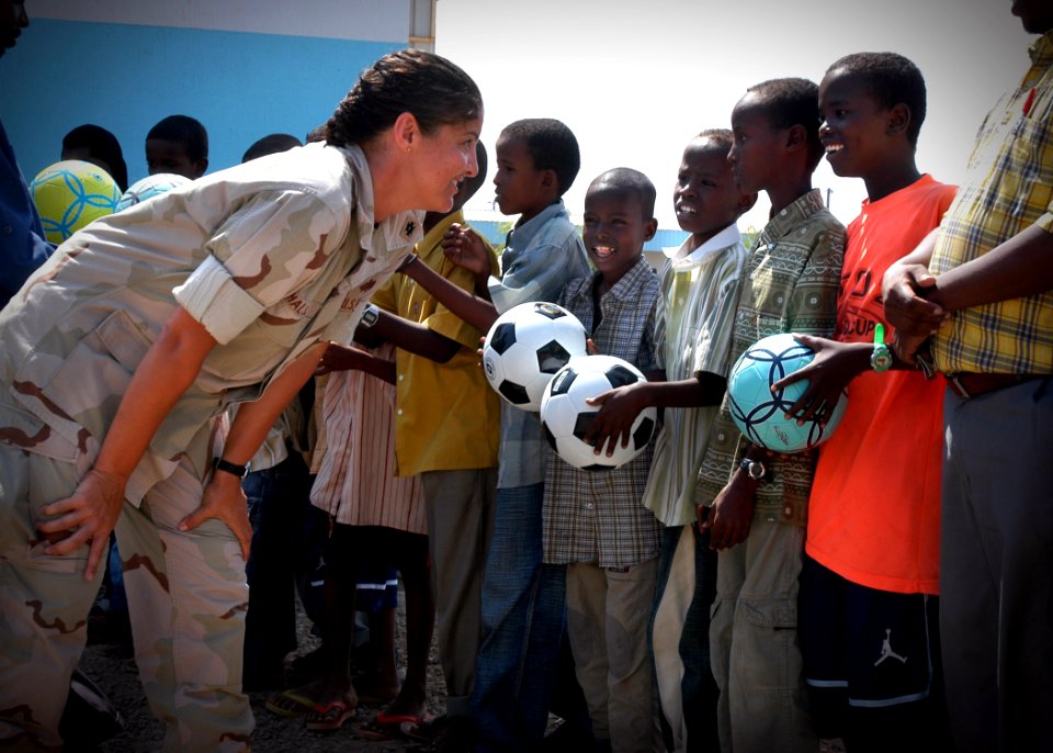 US Navy 061119-N-1328C-367 Lt. Cmdr. Wendy Halsey, from Honolulu, Hawaii, visits and hands out soccer balls collected by churches, schools and organizations in the United States
