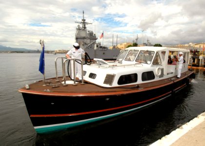 US Navy 061120-N-4965F-005 Boatswain's Mate 2nd Class Veronica Greene (left), bow hook for Commander, Navy Region Hawaii barge crew, hauls in a line from the bow of the barge as it gets underway