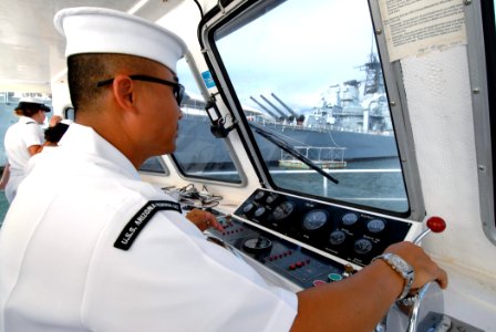 US Navy 061115-N-4965F-009 Boatswain's Mate 1st Class Toan Le, coxswain for the USS Arizona Memorial Detachment white boat crew, passes the Battleship Missouri Memorial during a white boat tour of Pearl Harbor