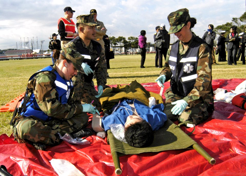 US Navy 061115-N-4649C-089 Doctors and hospital corpsmen from U.S. Naval Hospital Yokosuka, Japan Special Medical Operation Response Team (SMORT), assist a patient during a mass casualty drill held at the Hakozaki Fuel Terminal