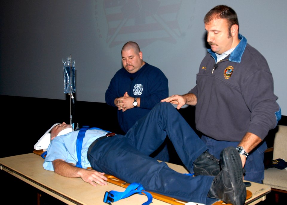 US Navy 061108-N-1082Z-003 Pat Kelly and Scott Mc Intyre firefighter- paramedics from the Orlando fire department simulate medical procedures a trauma victim would go through following a car crash