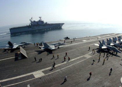 US Navy 061120-N-8907D-001 The Tarawa-class amphibious assault ship USS Saipan (LHA 2) navigates alongside the Nimitz-class aircraft carrier USS Dwight D. Eisenhower (CVN 69)