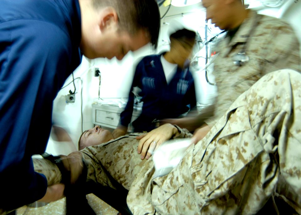 US Navy 061121-N-2636M-015 Lance Cpl. Sean R. Ramsey simulates injuries during a mass casualty drill while hospital corpsmen aboard the amphibious assault ship USS Bataan (LHD 5) train to respond to the situation