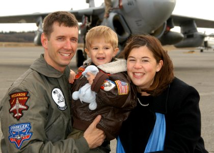 US Navy 061117-N-6247M-019 Lt. Cmdr. Darren Guenther greets his son and wife after returning home from deployment photo