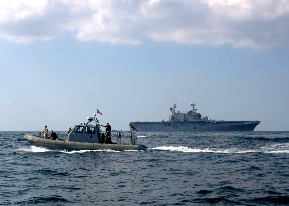 US Navy 061121-N-8547M-065 A Rigid Hull Inflatable Boat (RHIB) conducts Visit, Board, Search and Seizure (VBSS) training off the starboard side of amphibious assault ship USS Saipan (LHA 2)