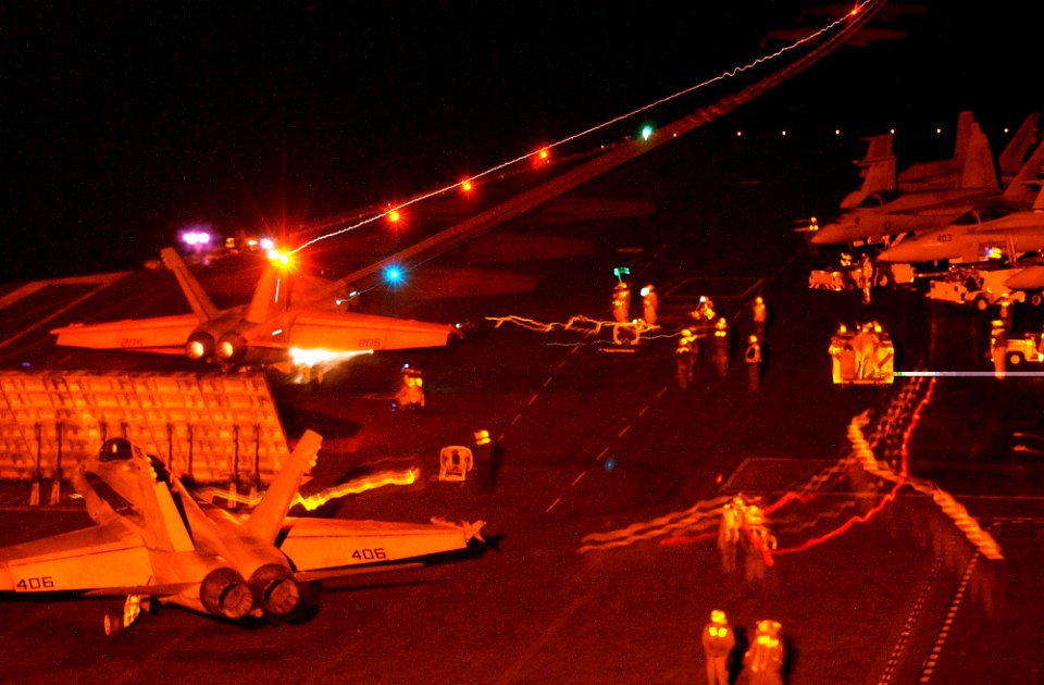 US Navy 061116-N-7130B-013 An F-A-18E Super Hornet lights up the night as it launches from the number-two steam powered catapult aboard USS Ronald Reagan (CVN 76)